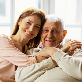 Knoxville grandfather smiling with granddaughter, showcasing the family joy protected by our senior insurance plans.